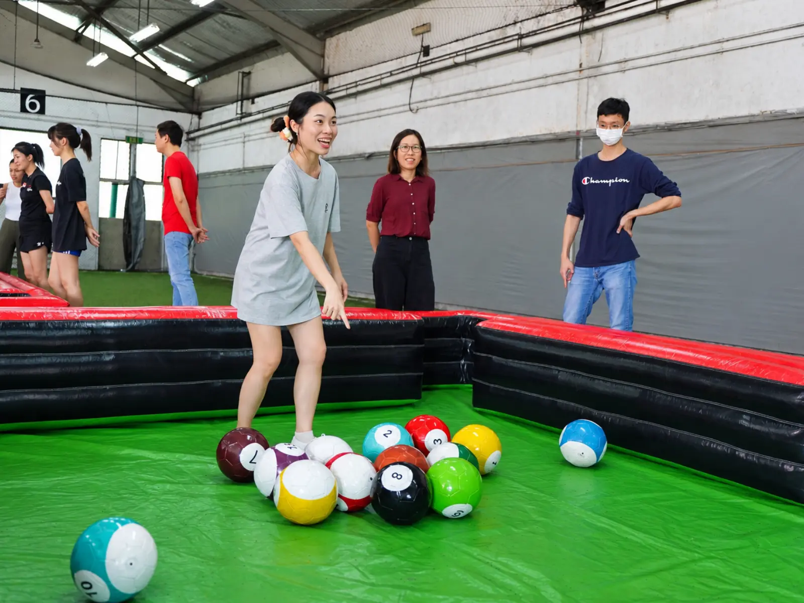 A player takes a shot on the Poolball table