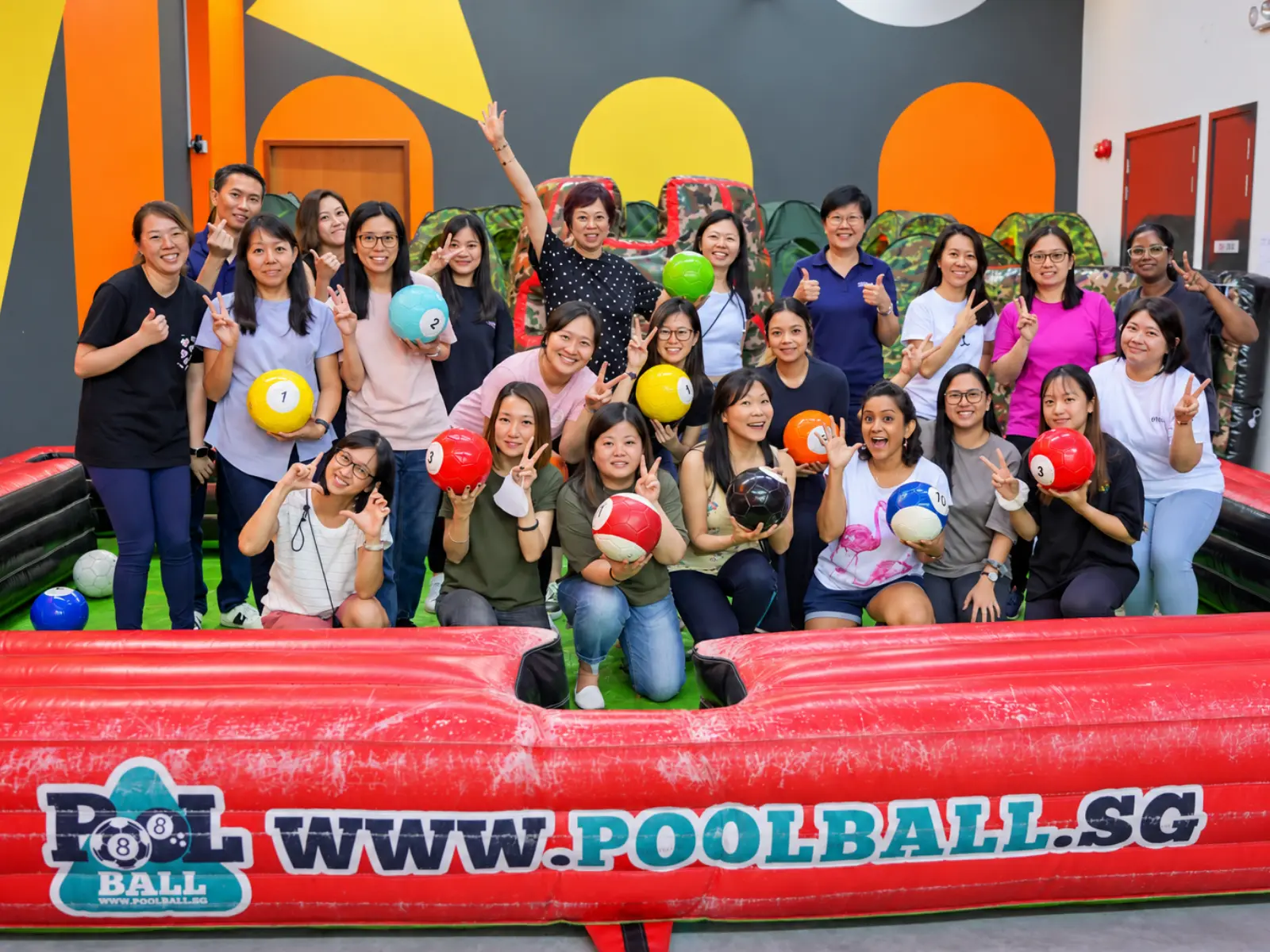 A large company group at the Poolball table