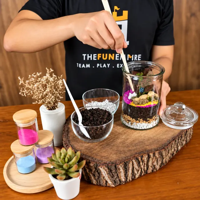 A facilitator layers pebbles, soil and coloured sand in a terrarium jar