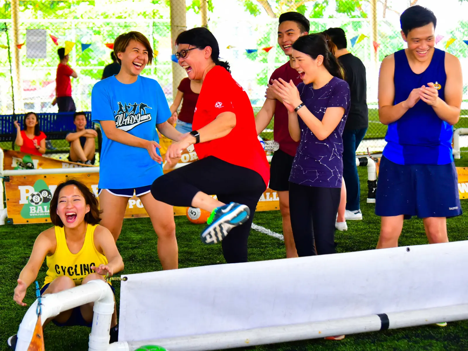 Staff seated on the turf during a company family day