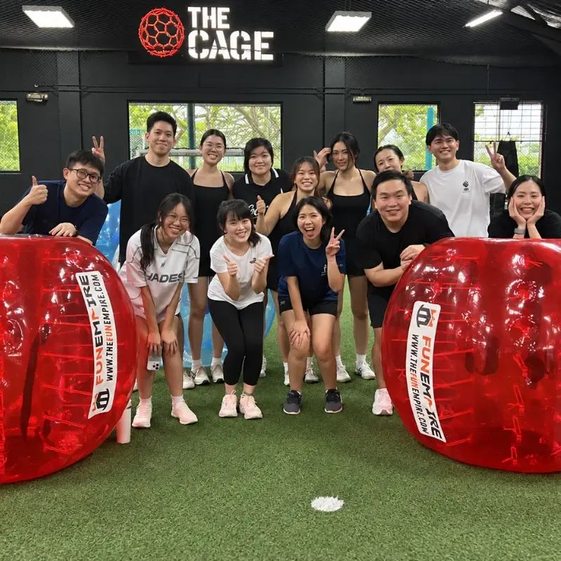 Participants lined up in Bubble Soccer suits before a game