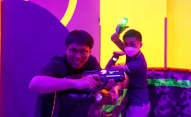 players communicating in a game of laser tag in singapore