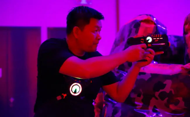 player aiming in a game of laser tag in singapore