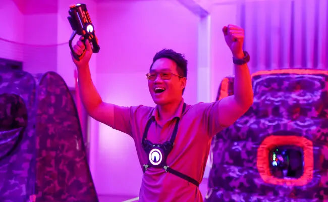 player celebrating in a game of laser tag in singapore