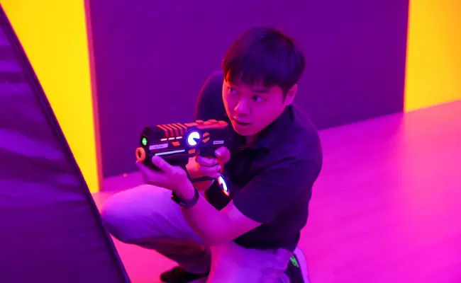 player crouching in a game of laser tag in singapore