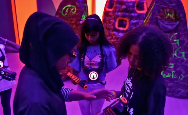 professional facilitators briefing kids before a laser tag session