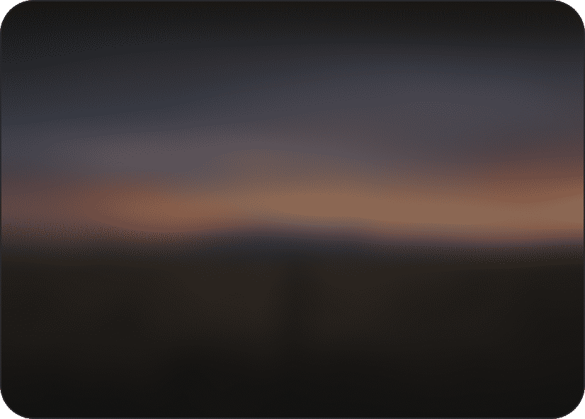 Blurred landscape with an orange band of cloud at sunset.