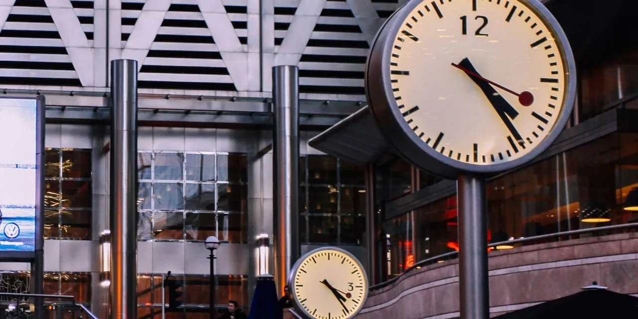 Clocks at Modern Transit Station for A Day in the Life of an Investment Banking Analyst