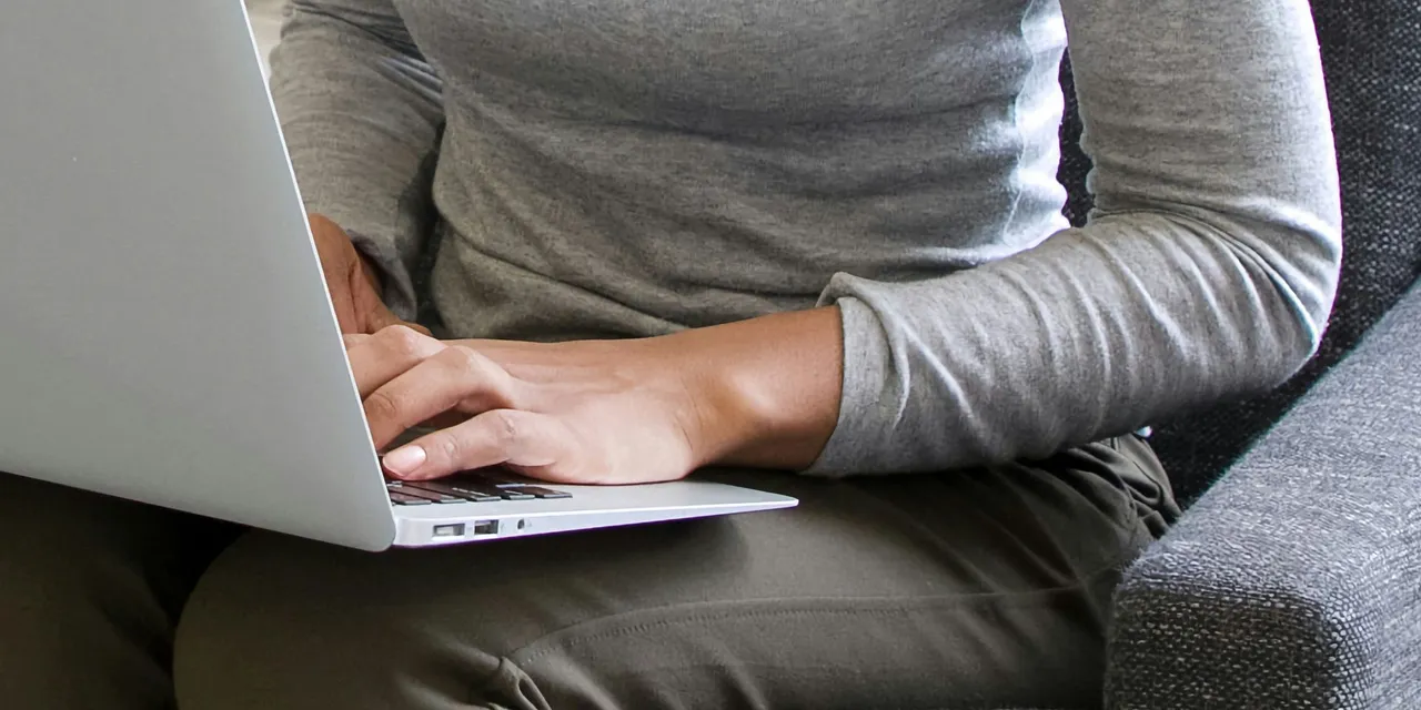 Person Working on Laptop at Home for How to Become a Financial Analyst: Essential Skills That Land The Job
