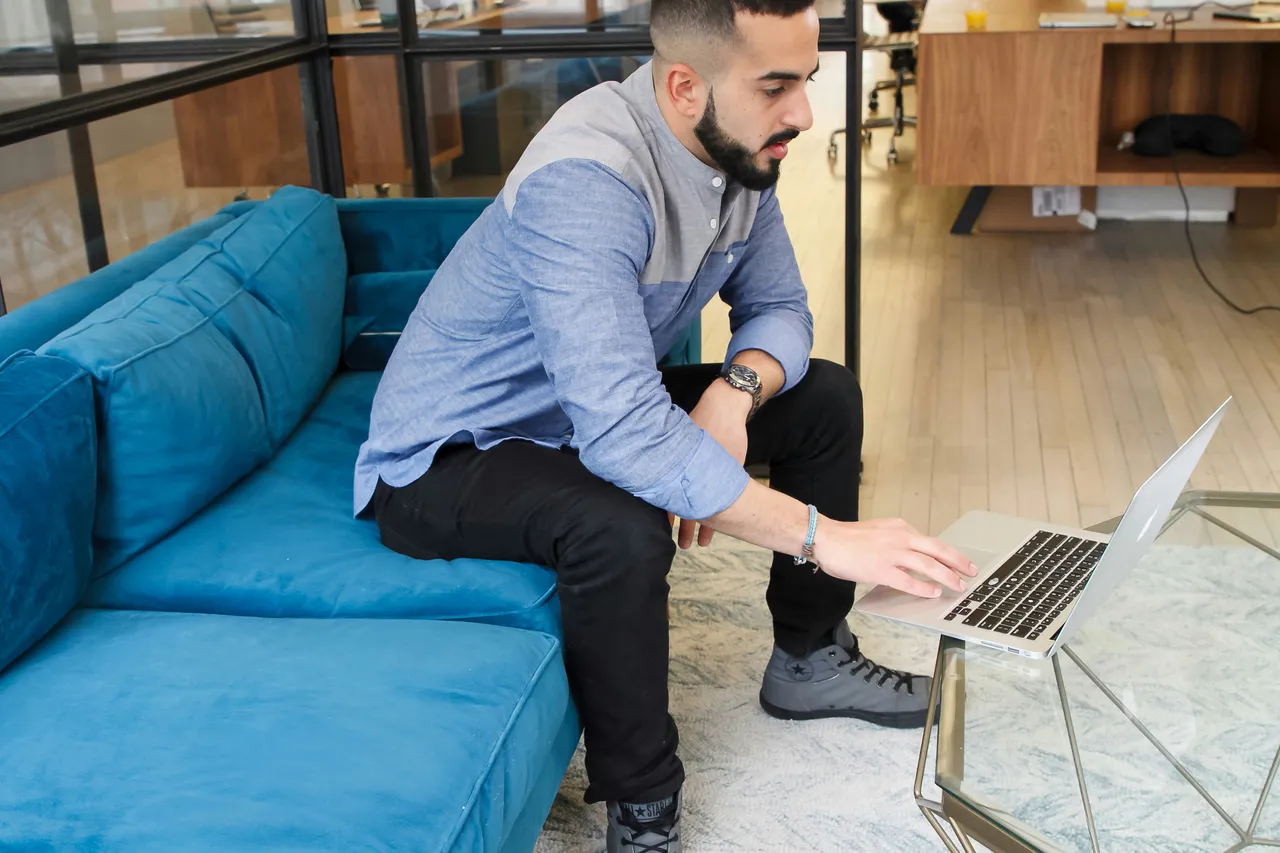 Professional Man Working on Laptop in Modern Office for The Day in the Life of a Wealth Manager