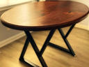 Custom round solid walnut table on a blackened steel cross base