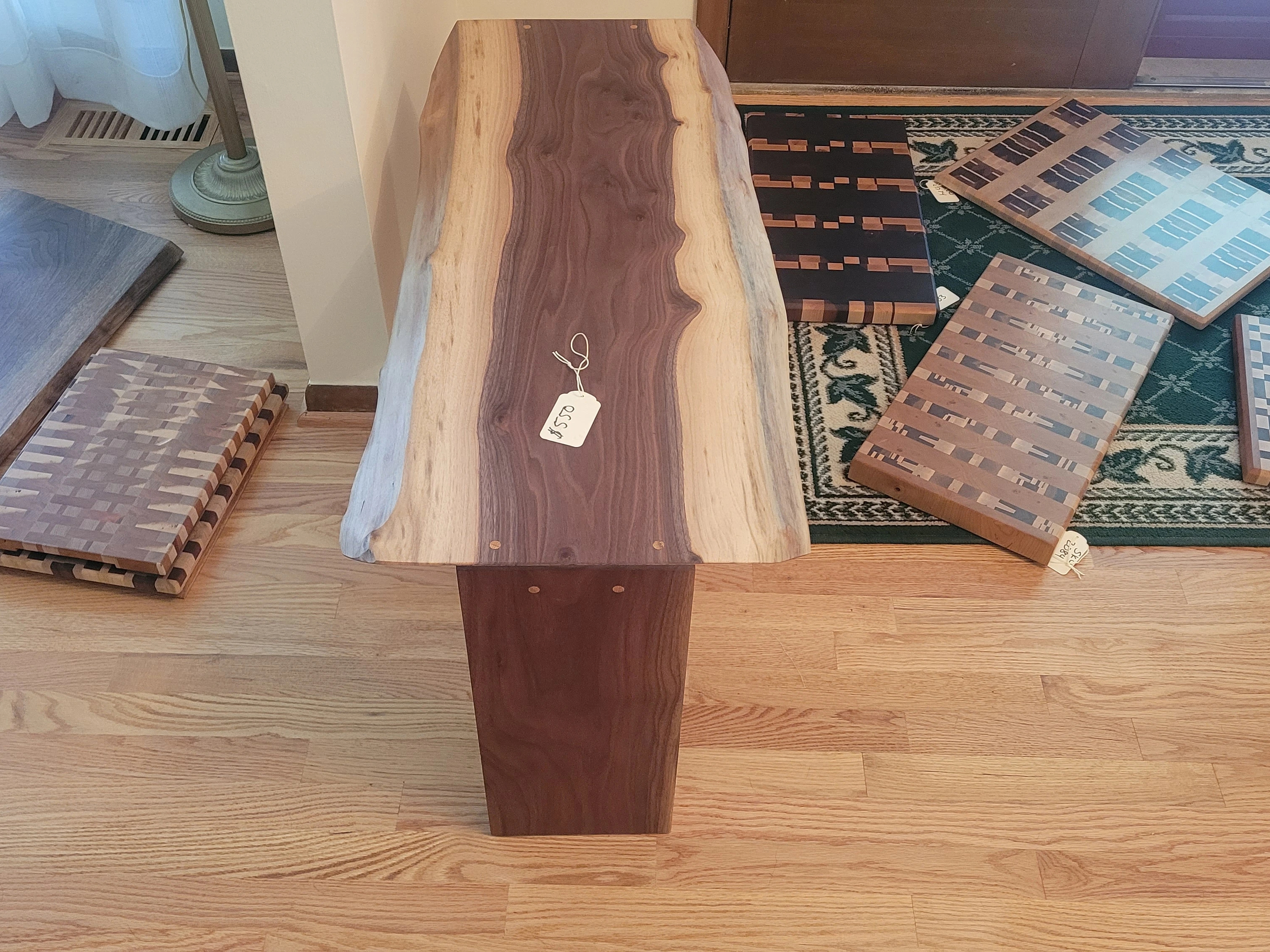 Back angle of live edge walnut bench highlighting smooth joinery