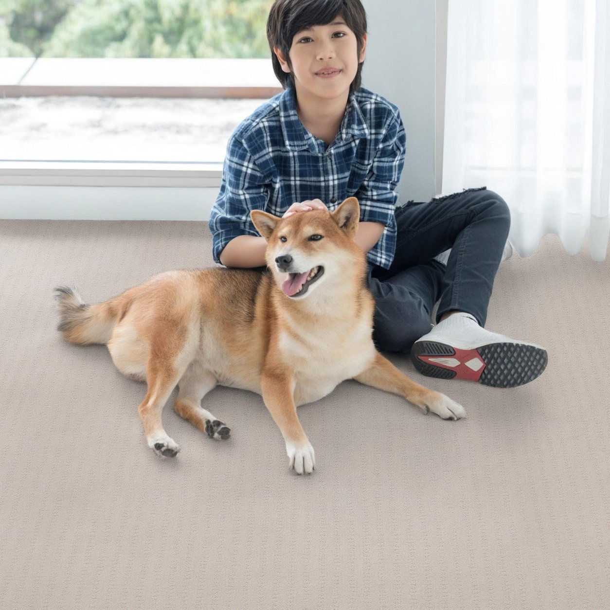 boy playing with puppy on carpet floor in a Vancouver home