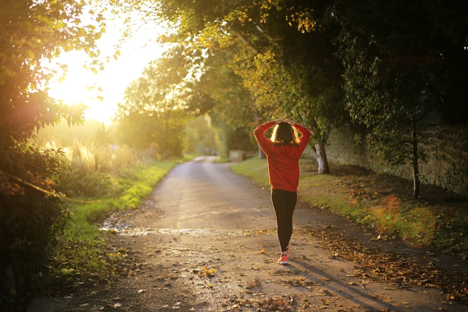 Woman walking along a sunlit path