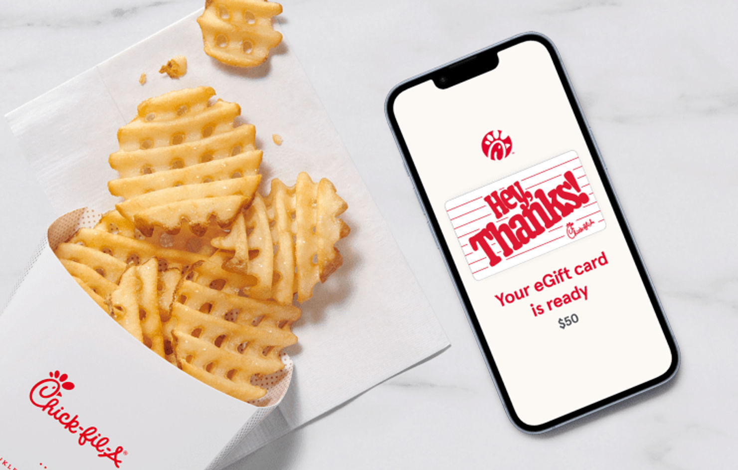 A smartphone with a Chick-fil-A® Gift Card on the screen that says “Hey, Thanks!”, sitting next to Waffle Fries