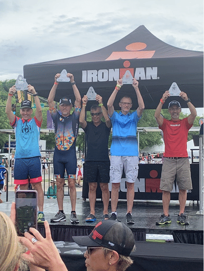 Dr. Porter on the podium at an Ironman race