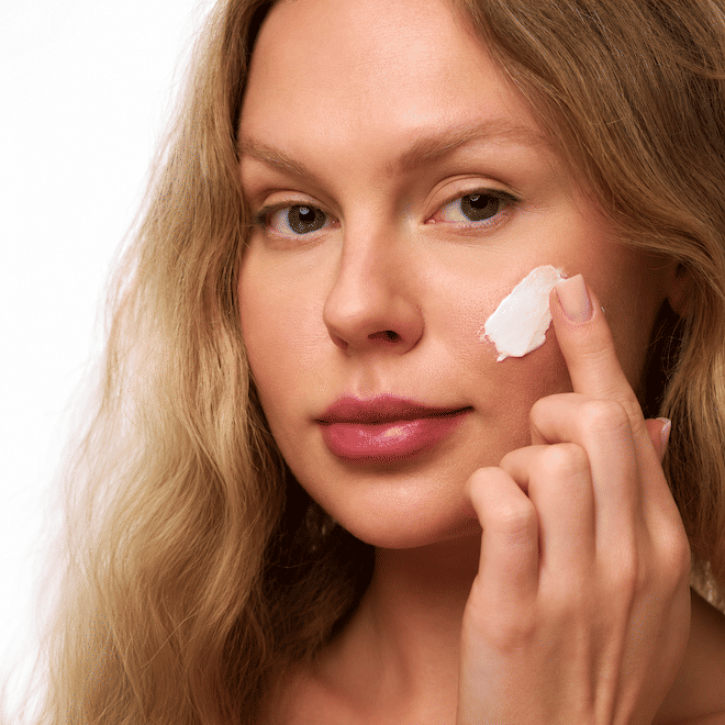 Woman applying Nu Skin skincare