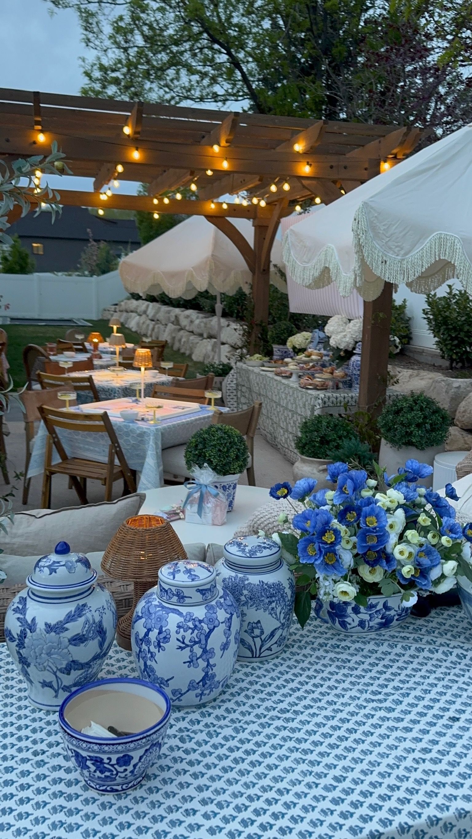 Blue flowers and porcelain beside an outdoor mahjong gathering