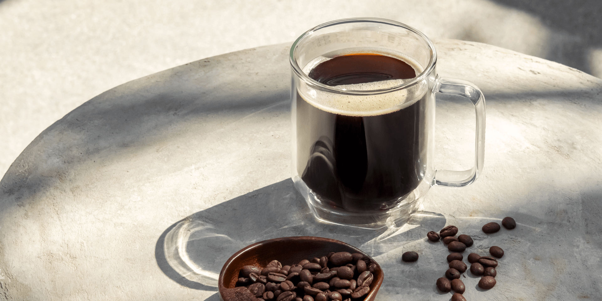 Coffee beans and a brewed cup