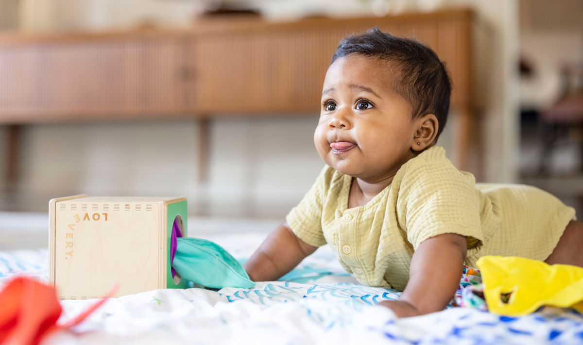 Baby practicing tummy time with the Magic Tissue Box