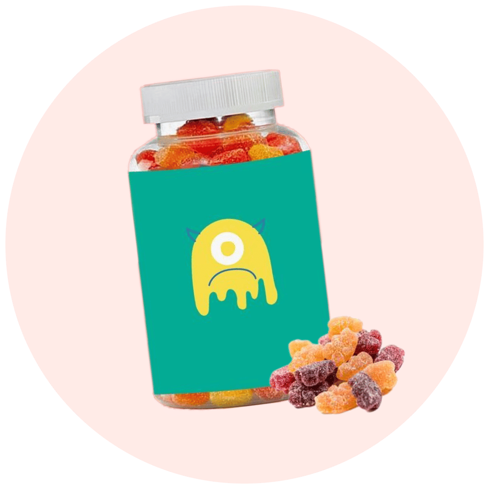Kids vitamin tablets in colorful shapes, bottle with playful monster label, healthy nutrition for children