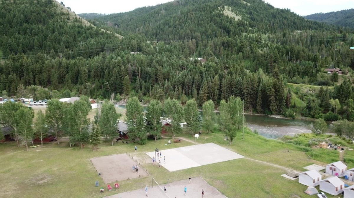 The sand volleyball courts and sport court, with the river behind them