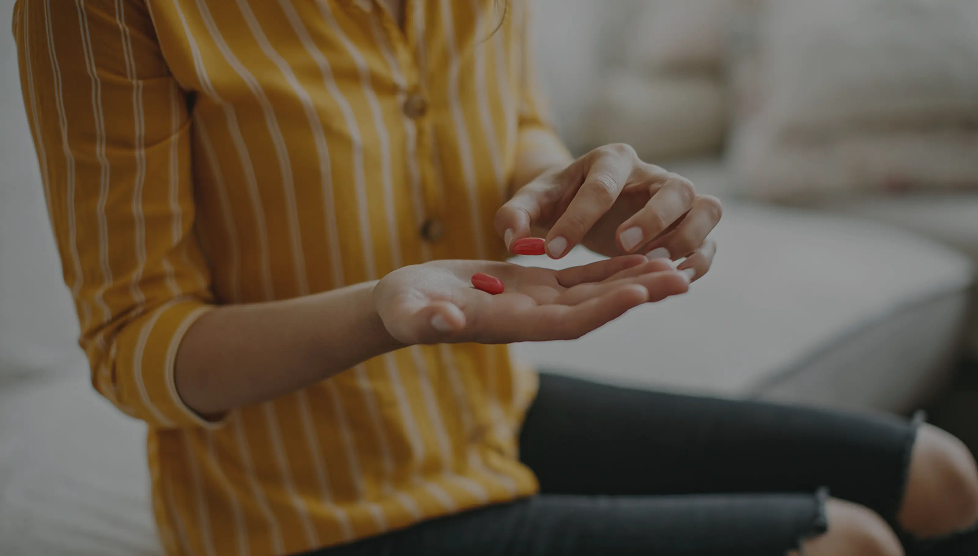 A woman holding a cup in both hands.