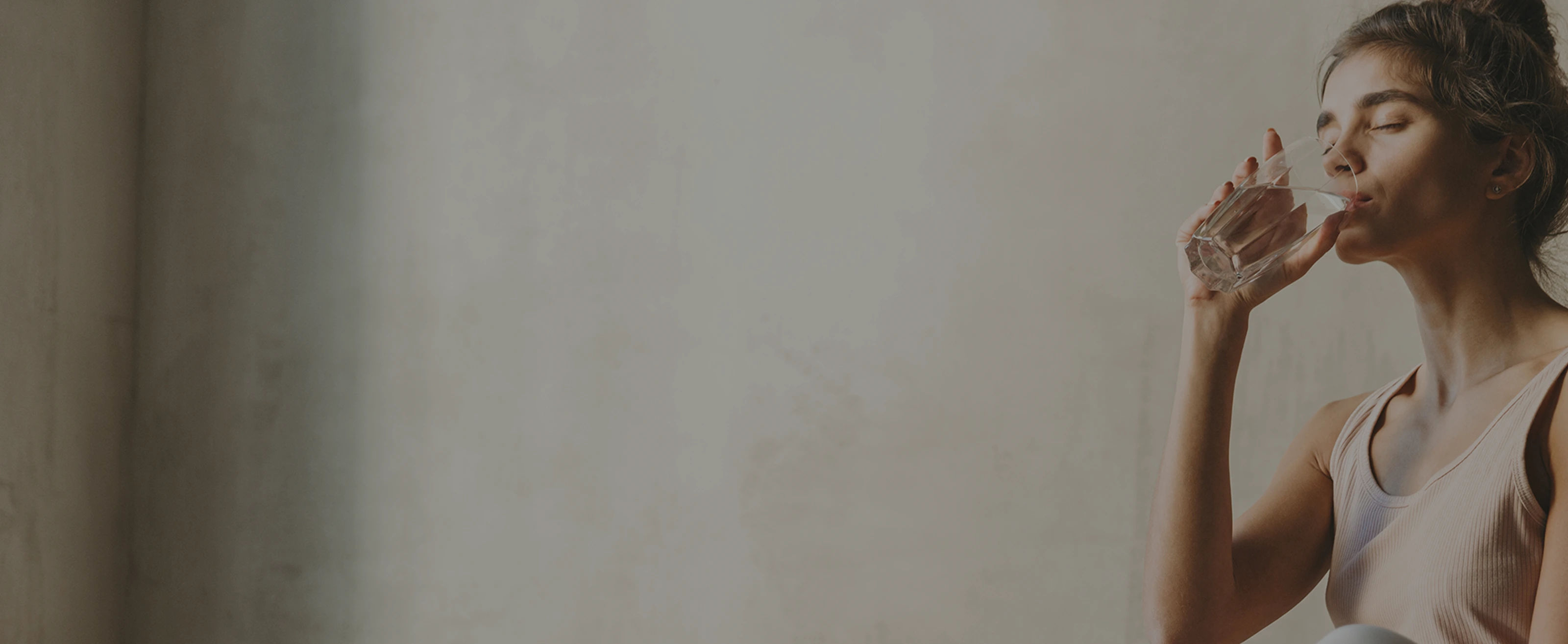 Woman in profile drinking water