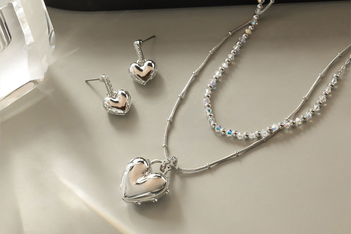 Full Heart necklace and earrings styled on a model
