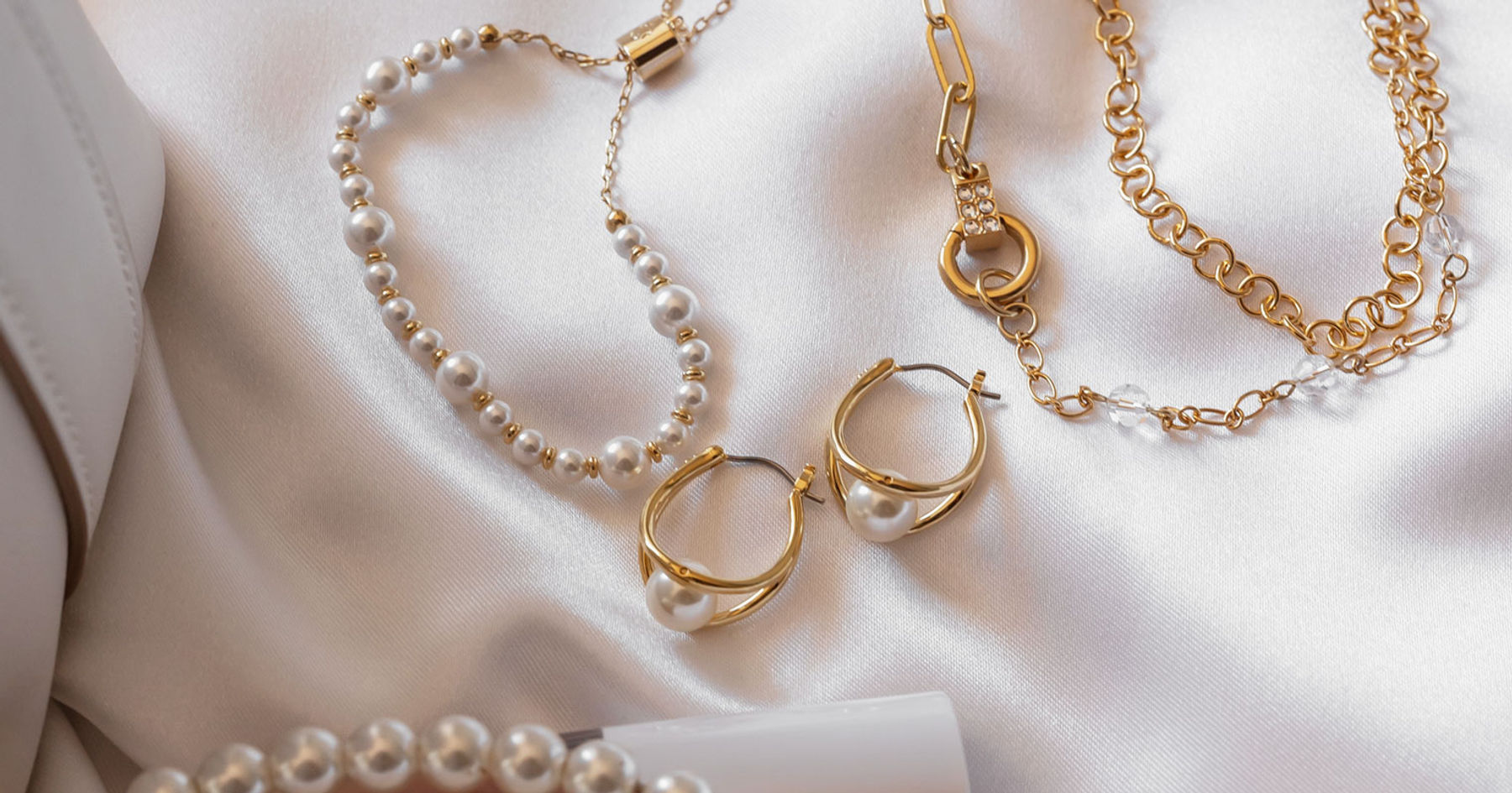 Golden pearl jewelry styled in a lifestyle setting