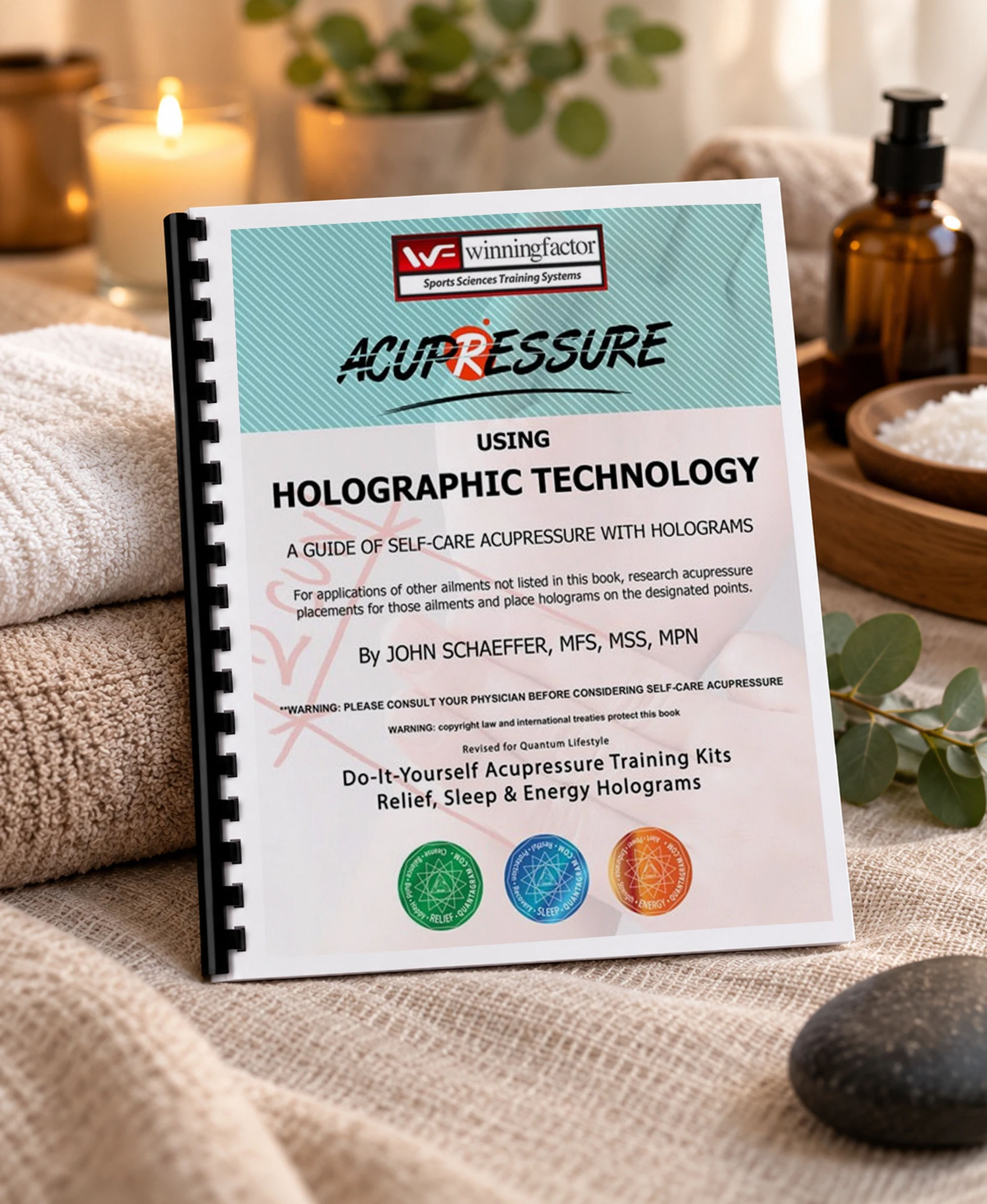 The acupressure guide on a spa table with folded towels, a candle and eucalyptus