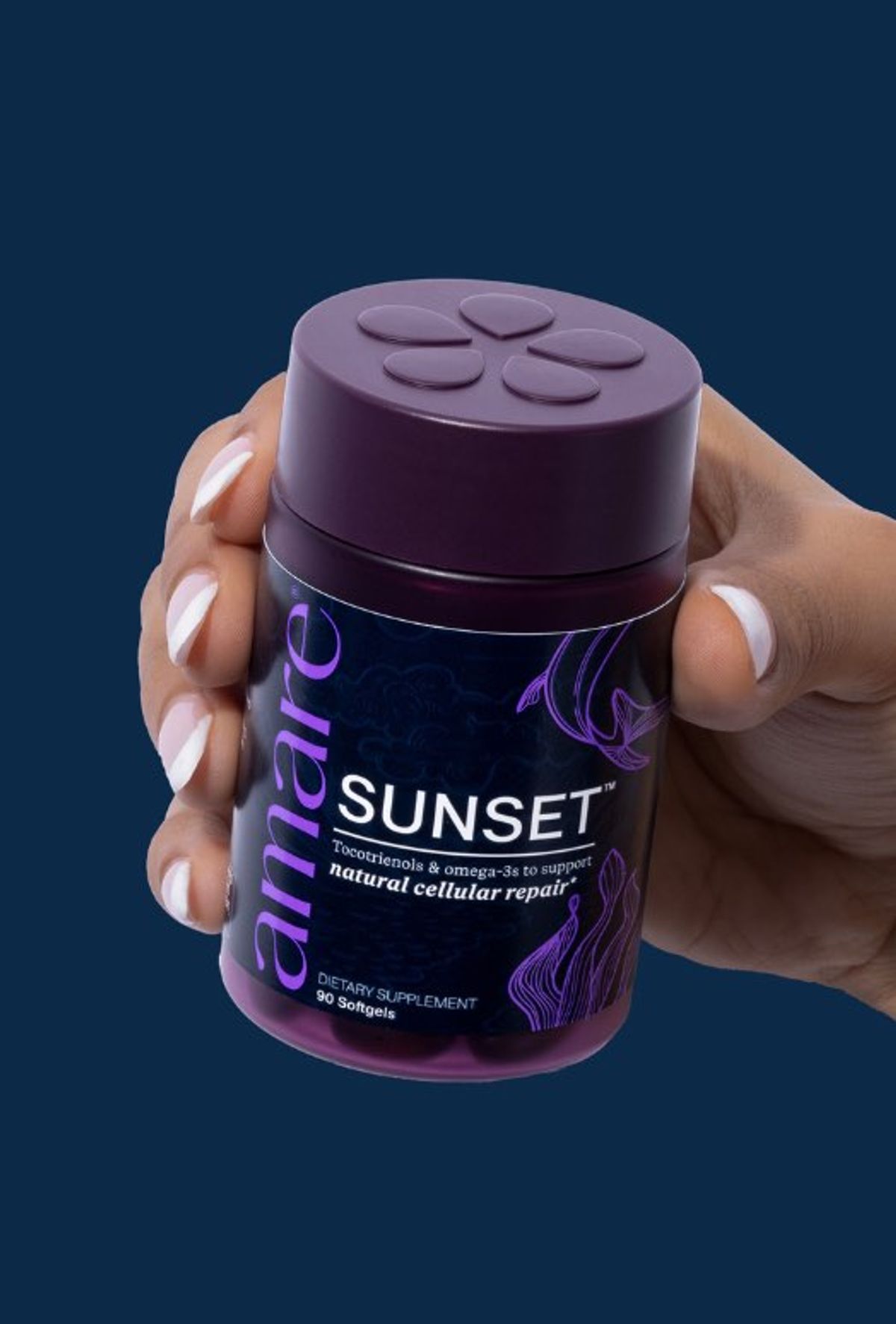 A hand holds a dark purple jar of Amare SUNSET against a deep navy background.