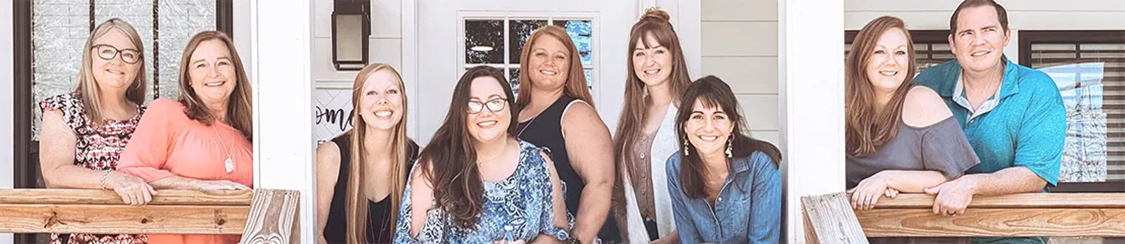 Plexus Brand Ambassadors smiling together on a front porch.