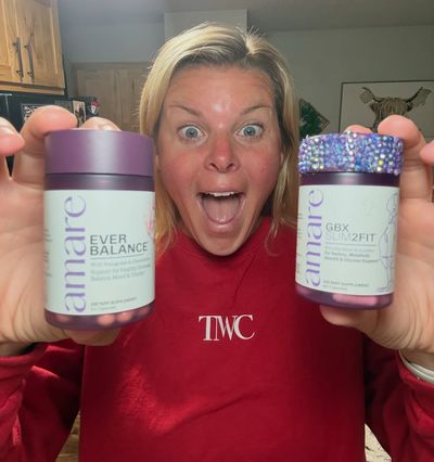 Amare community member holding two Amare supplement jars