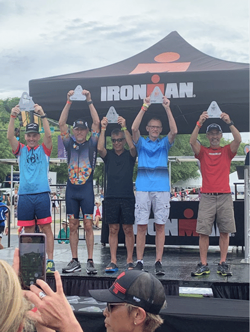 Dr. Porter on the podium at an Ironman race