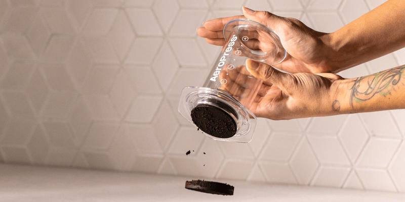 Hand pressing the AeroPress plunger