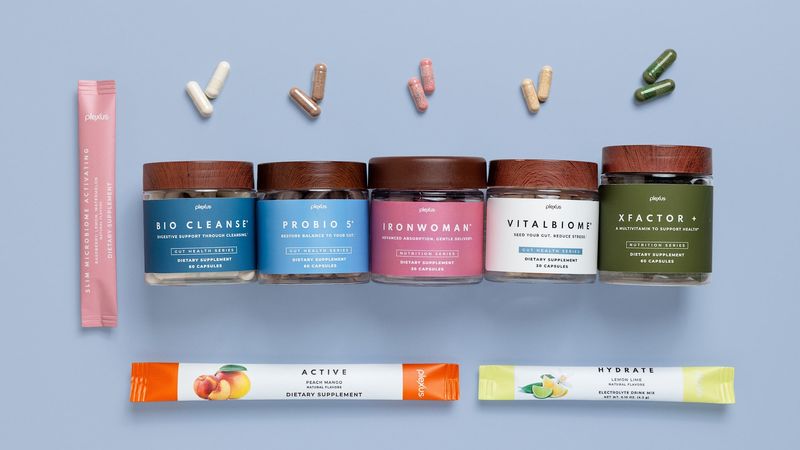 Five Plexus supplement jars with capsules and stick packs.