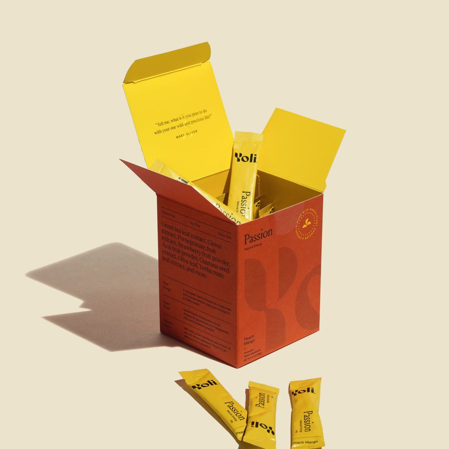 An open box of Yoli Passion with yellow single-serving packets
