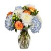 Orange Skies featuring Blue Hydrangea, White Disbuds, Orange Roses accented with Green Hypericum