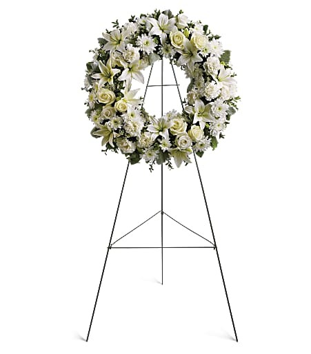White 18" Serenity Wreath featuring white lilies, carnations and mums