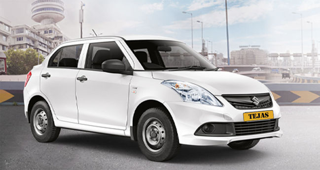 A white Suzuki car parked on a city road, with a backdrop of modern buildings and a cloudy sky.