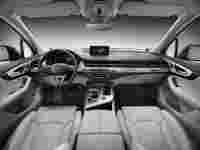 Luxury car interior featuring leather seats, a sleek dashboard, and a central infotainment display. Modern and minimalistic design.