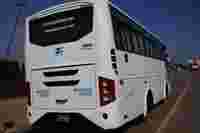 White luxury tempo traveller on road in Mysore