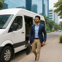 A man in a suit walks with a briefcase near a white van, in an urban setting with glass buildings.