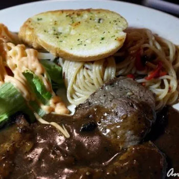 Sizzling Beef Steaks served with pasta