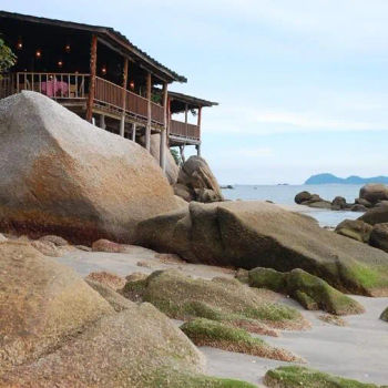 Sitting on stilts, on a rock outcrop