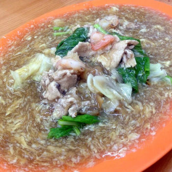 Wat tan Hor-flat rice noodle in a starchy egg gravy with Choy Sam, Chinese round cabbage, pork slices and prawn.