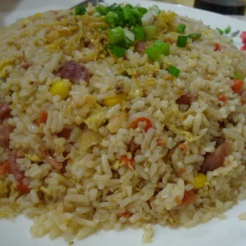 Fried rice with diced carrot, Chinese sausage, egg and topped with freshly chopped spring onion and deep fried Anchovies