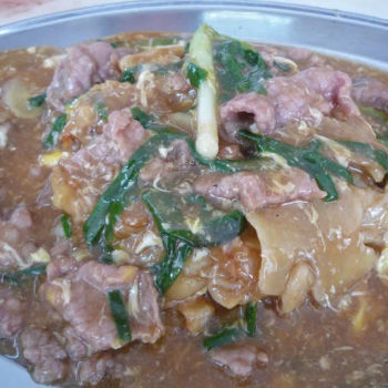 Beef Cooked With Kway Teow (Flat Rice Flour Noodle), Stalk Of Spring Onion, Sliced Ginger And A Thick Egg Gravy