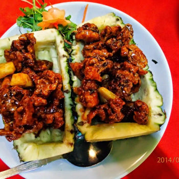 Fried chicken bites with pineapple of sweet and sour flavour